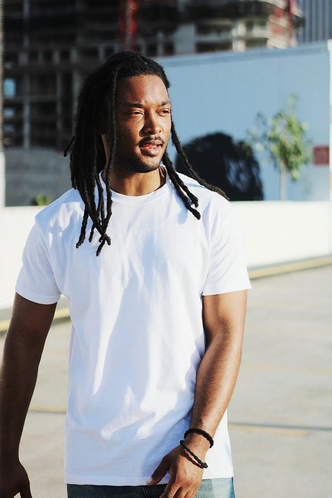 Man wearing Gman USA wholesale white t-shirt, clean background
